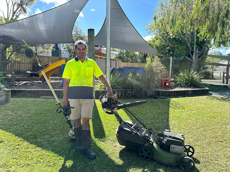 Kawana, owner of Beyond Lawnmowing, with his mower on a Whangarei lawn